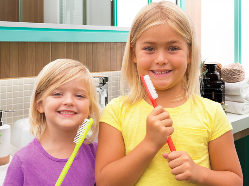 two girls with toothbrushes